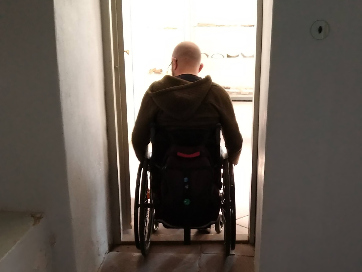 Rollstuhlfahrer in einer Tür.